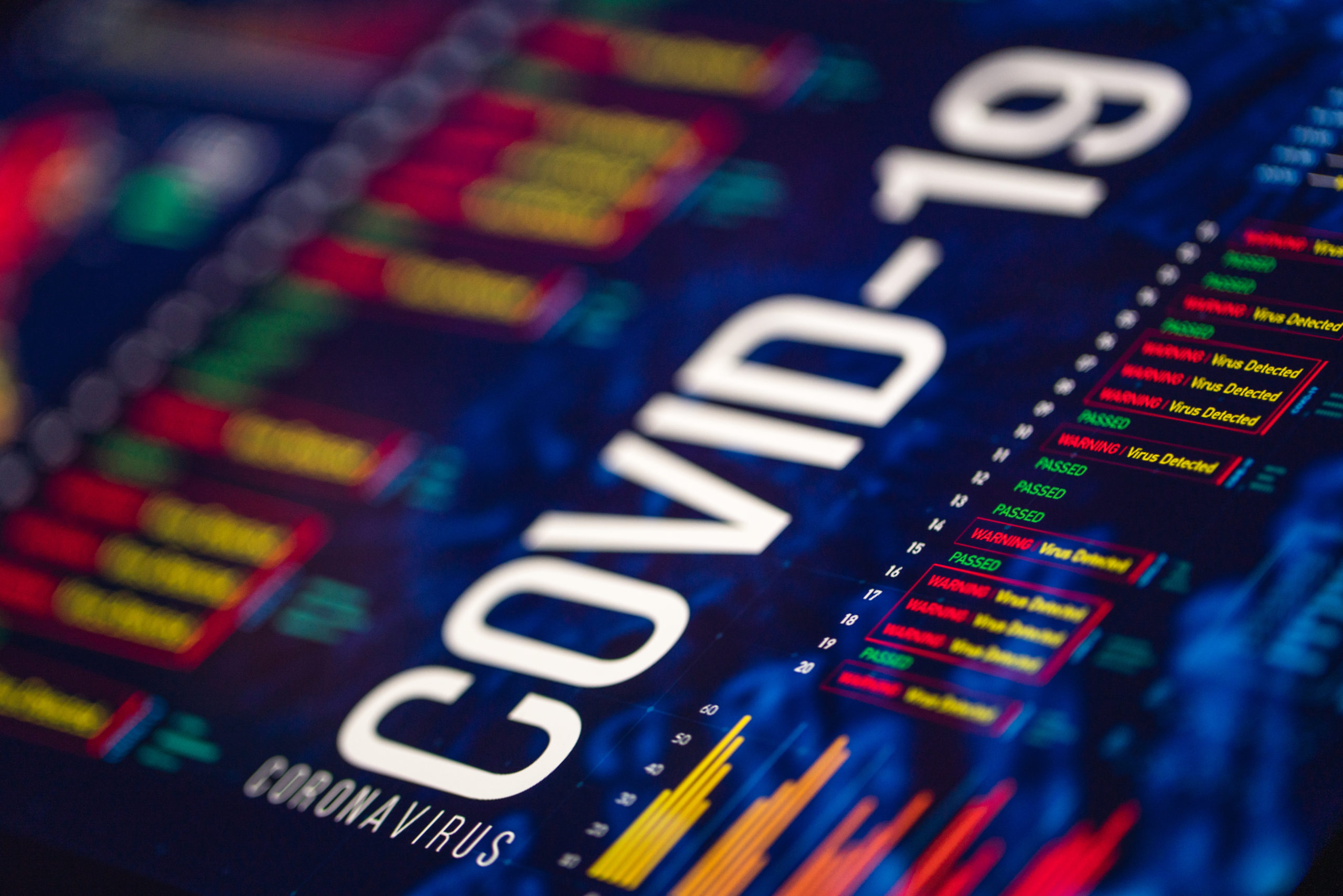 Digital display showing COVID-19 statistical charts and graphs, representing the data collected from surveying the first quarantined community in the United States