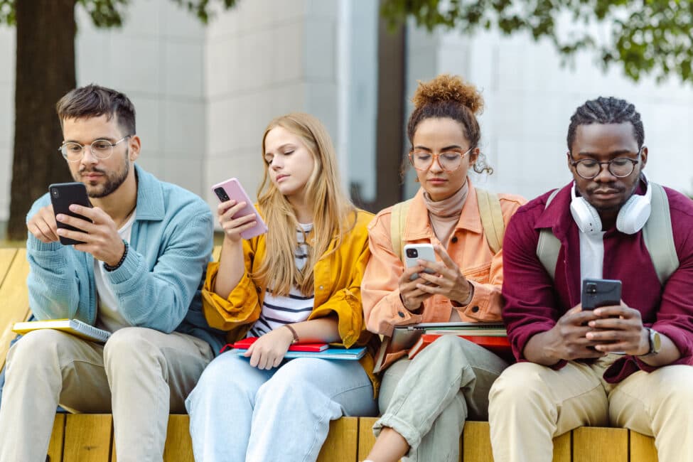 Person holding smartphone with multiple social media and notification icons floating above, representing the constant influx of information demanding attention