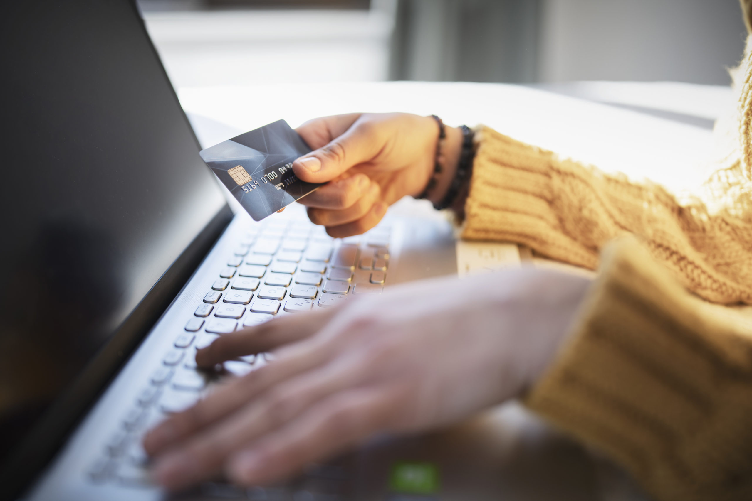 Person using laptop to set up AWS billing for CloudResearch MTurk Toolkit, illustrating the new post-payment option