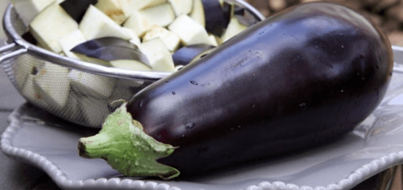 A whole eggplant on a plate next to a strainer of chopped eggplant, used as a cultural knowledge check in a survey data quality study