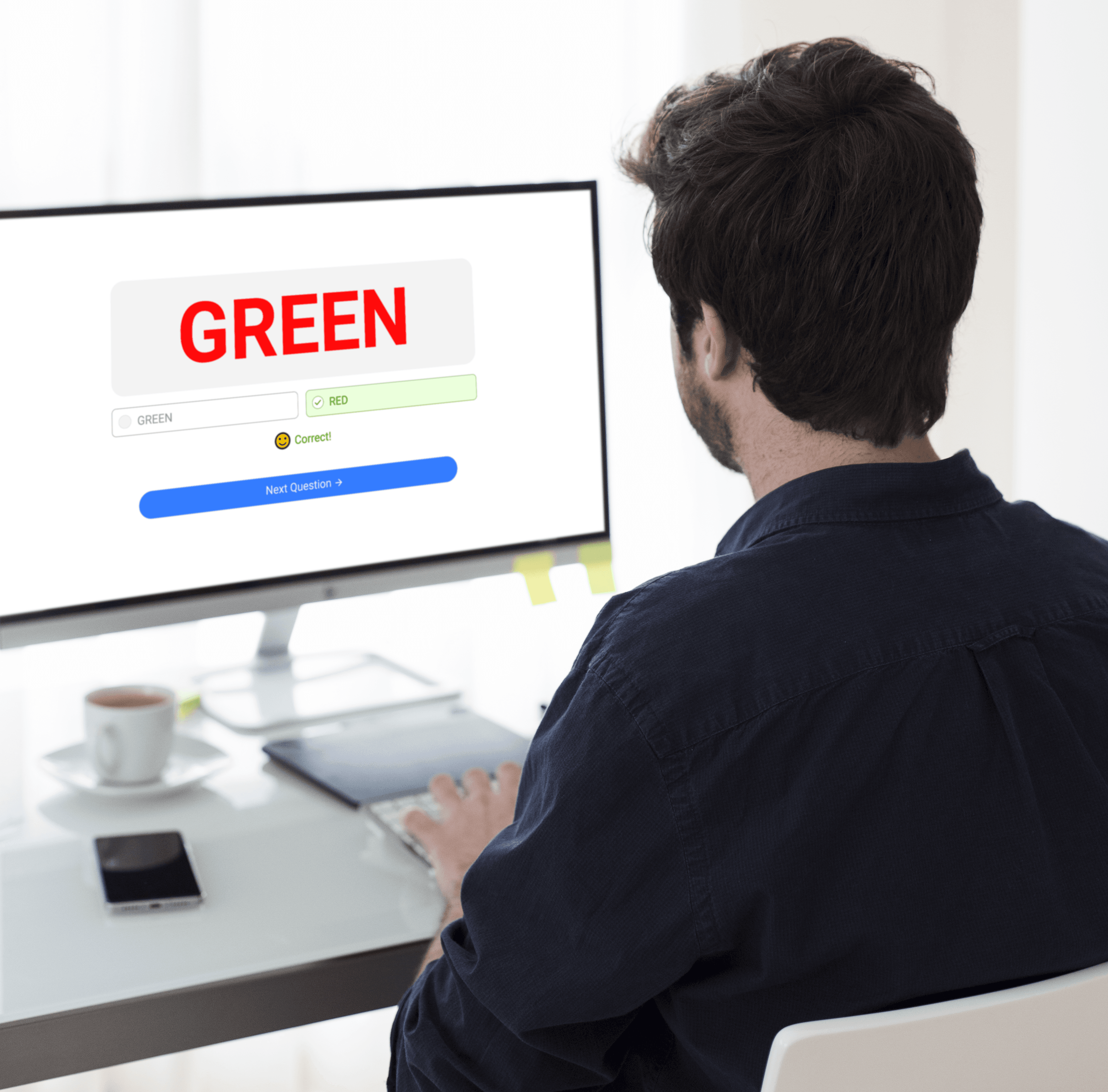 Person completing a cognitive performance task on a computer showing the word GREEN displayed on screen, demonstrating how software measures reaction time and accuracy